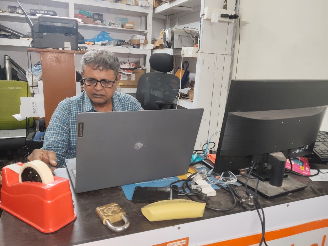 R. Sairam, owner of Shankara Systems, working at the service desk in Nanganallur, Chennai