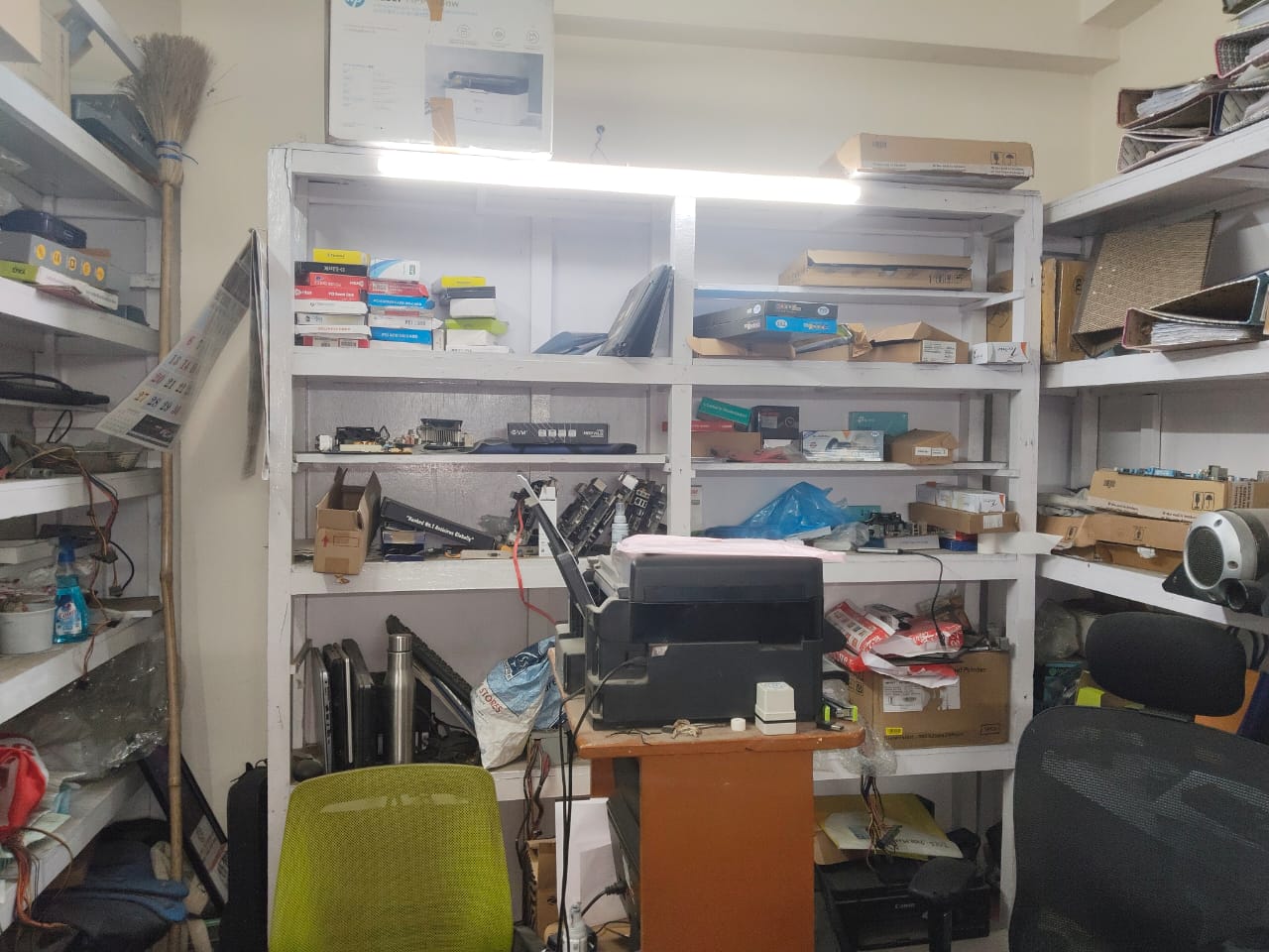 Printer parts and circuit boards on shelves at Shankara Systems